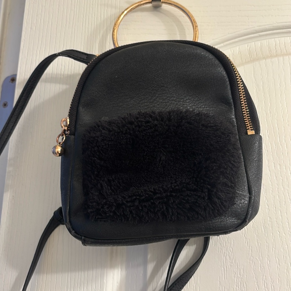 black mini backpack with gold detailing